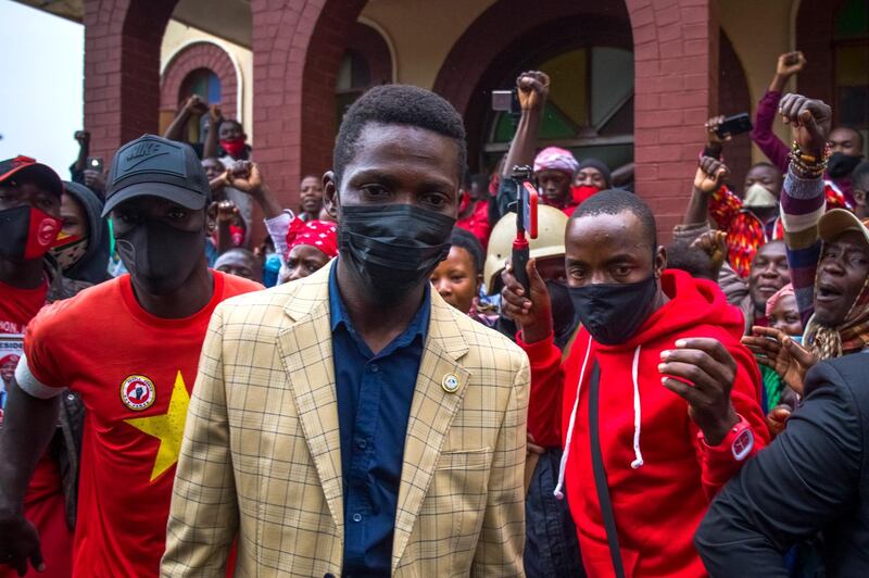 Supporters cheer Bobi Wine as he departs from his last church service ahead of the presidential elections at Namungoona Orthodox Church in Kampala on January 10, 2021. EPA