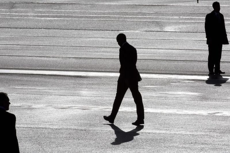 President Barack Obama, center, and two secret service agents are silhouetted as he walks towards Marine One helicopter upon arrival at Schiphol Amsterdam Airport, Netherlands. Peter Dejong / AP 
