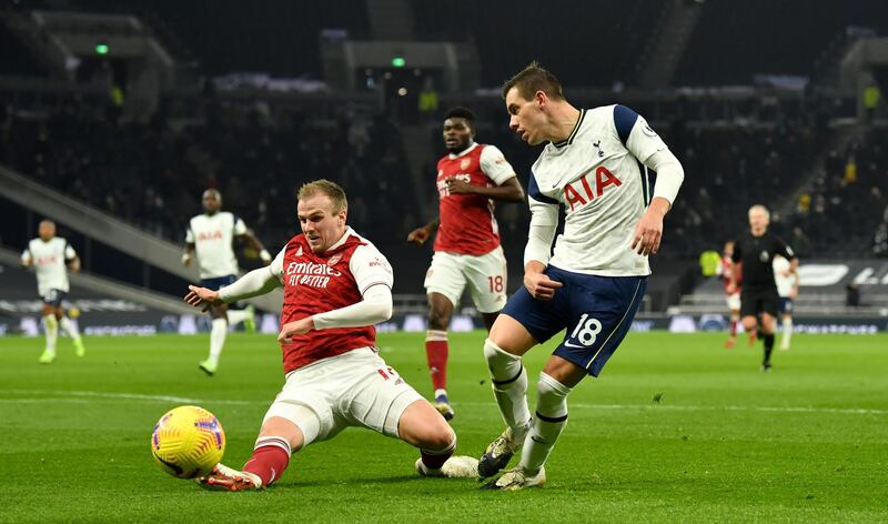 Arsenal's Rob Holding, left, attempts to block the cross from Tottenham Hotspur's Giovani Lo Celso. PA