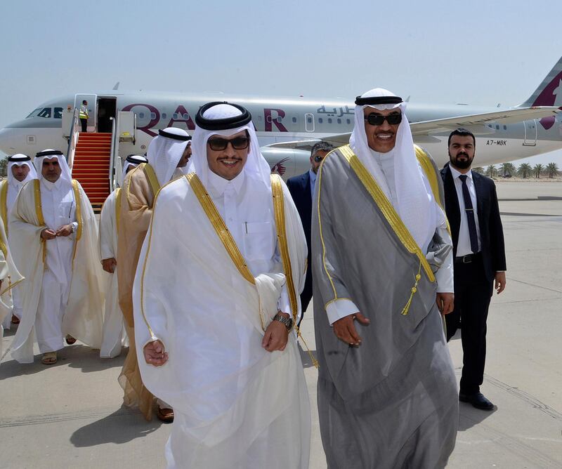 Qatari foreign minister Sheikh Mohammed bin Abdulrahman Al Thani, left, with Kuwaiti foreign minister Sheikh Sabah Khaled Al Sabah on his  arrival in Kuwait on July 3, 2017. KUNA via AP