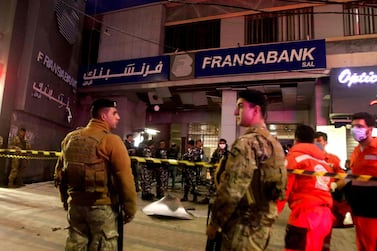 Lebanese security forces guard the entrance of a Fransabank branch in the southern city of Saida that was attacked with an explosive device on April 25, 2020. AFP