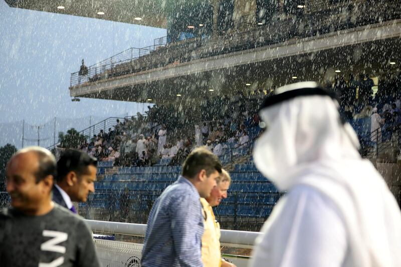 ABU DHABI , UNITED ARAB EMIRATES , November 25  ��� 2018 :- Spectators watching the horse race during the rain at the Abu Dhabi Equestrian Club in Abu Dhabi. ( Pawan Singh / The National ) For News/Instagram 