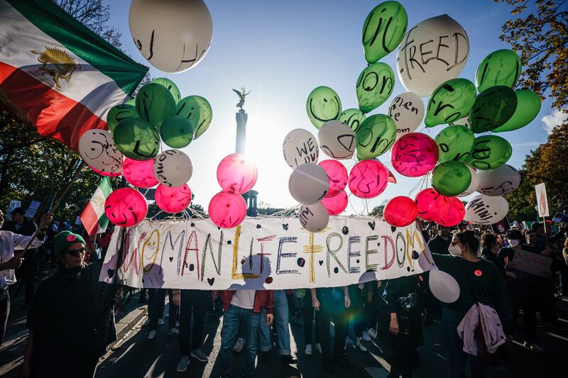 Demonstrators hold a banner reading 'Woman, Life, Freedom' during the rally in Berlin. EPA