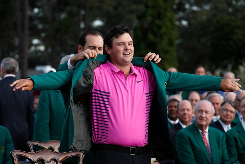 Sergio Garcia of Spain (rear), last year's Masters' champion, helps put the Green Jacket on 2018 Masters winner Patrick Reed following final round play of the 2018 Masters golf tournament at the Augusta National Golf Club in Augusta, Georgia, U.S. April 8, 2018. REUTERS/Jonathan Ernst