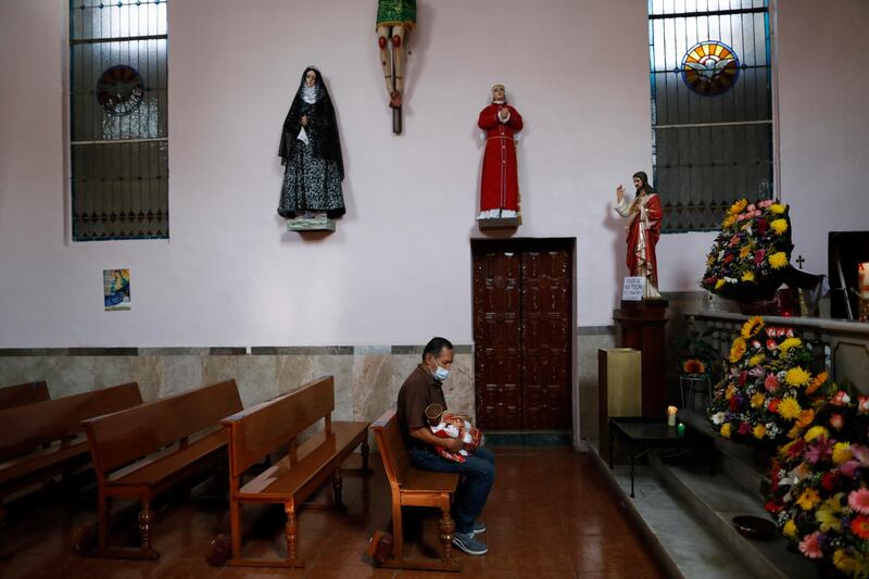 A man waits to have his Infant Jesus figure blessed with holy water at Purification of Our Lady of Candlemas Chapel in Mexico City. AP