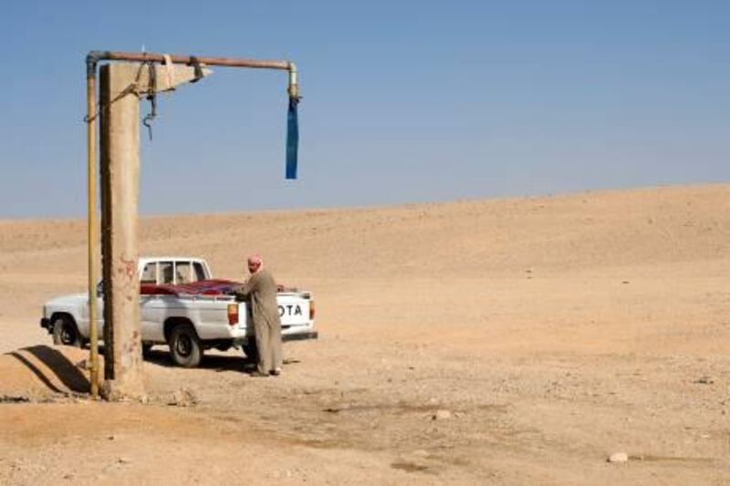 A beduin man at a water collection point, in eastern Homs governorate, November 2010. The UN has warned that after four consecutive years of drought and crop failure, Syria is now suffering its driest wet season in decades.

Credit: Phil Sands/The National