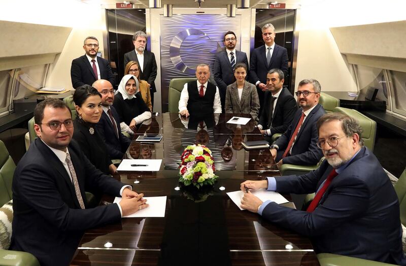 Turkey's President Recep Tayyip Erdogan, center, is surrounded by journalists and pro-government academicians in his plane en route back from Baku, Azerbaijan. The White House announced Tuesday that Vice President Mike Pence will travel to Ankara, Turkey on behalf of President Donald Trump and meet with Erdogan. AP