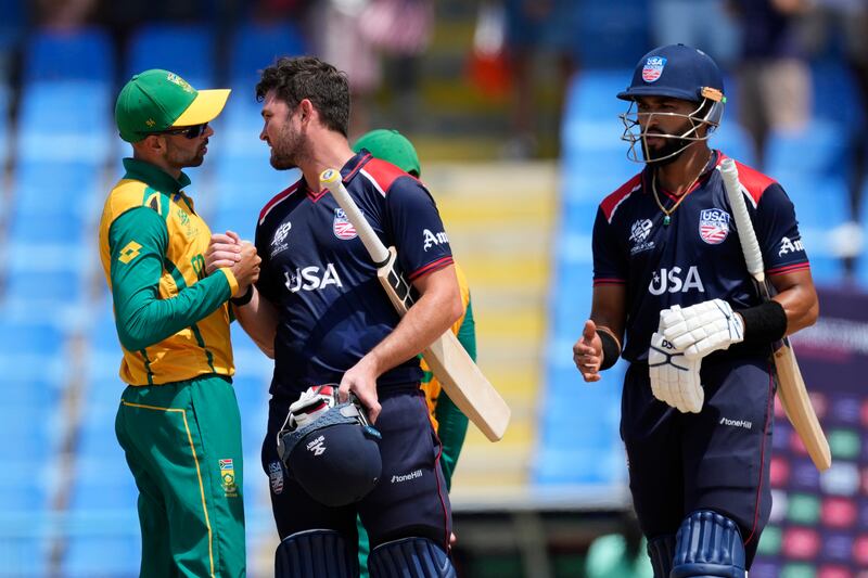 South Africa's Keshav Maharaj, left, and USA's Andries Gous at the end of the match. AP 