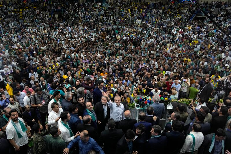 Iranian presidential candidate Masoud Pezeshkian, a reformist, waves during a campaign in Tehran. AP