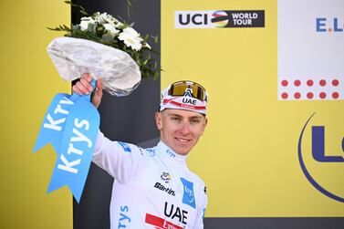 UAE Team Emirates team's Slovenian rider Tadej Pogacar celebrates on the podium with the Best Young rider jersey after the 2nd stage of the 109th edition of the Tour de France cycling race, 202,2 km between Roskilde and Nyborg, in Denmark, on July 2, 2022.  (Photo by Marco BERTORELLO  /  AFP)