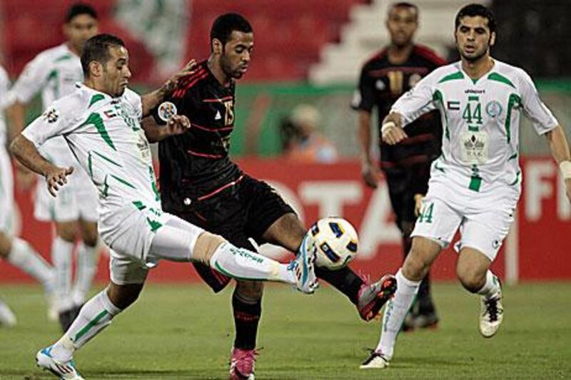 Mohammed Said fights for the ball with Hareb al Madhawi, left, and Hadif Saif Ahmed, right, in Qatar last night.