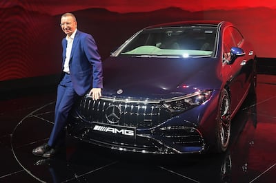 Martin Schwenk poses with a Mercedes electric vehicle in Mumbai. AFP 