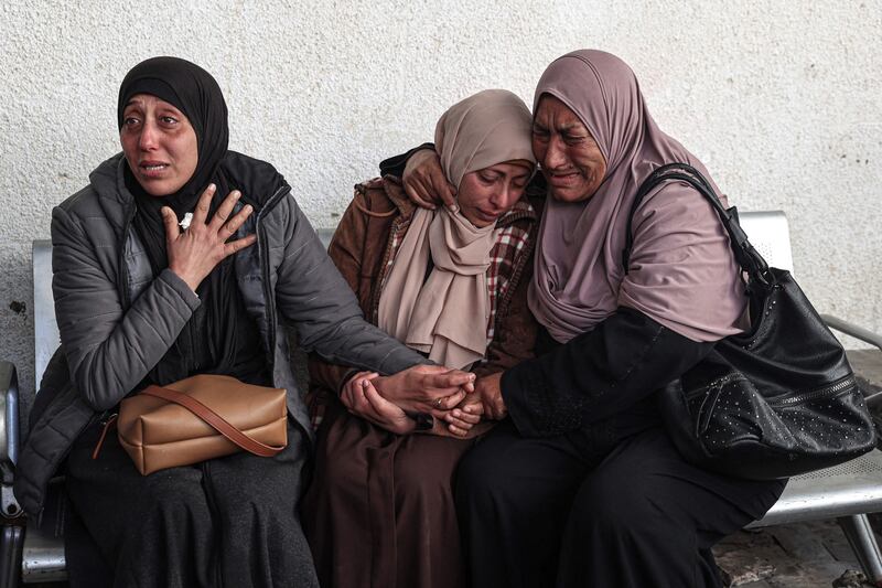 Palestinians mourn relatives killed in an overnight Israeli bombardment at Al Najjar hospital in Rafah. AFP