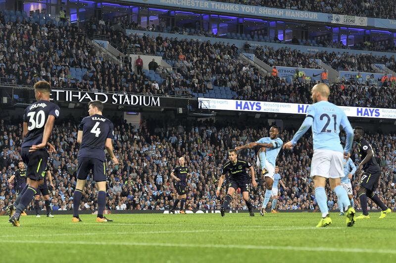 Manchester City's English midfielder Raheem Sterling (CR) scores his team's first goal during the English Premier League football match between Manchester City and Everton at the Etihad Stadium in Manchester, north west England, on August 21, 2017. / AFP PHOTO / Anthony Devlin / RESTRICTED TO EDITORIAL USE. No use with unauthorized audio, video, data, fixture lists, club/league logos or 'live' services. Online in-match use limited to 75 images, no video emulation. No use in betting, games or single club/league/player publications.  / 