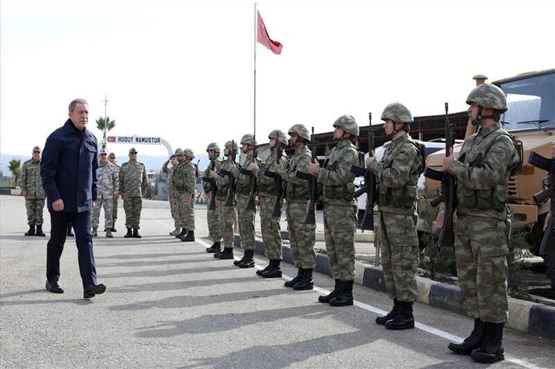 Turkish Defence Minister Hulusi Akar (L) arriving at the command coordination center near Syrian border in Hatay. AFP