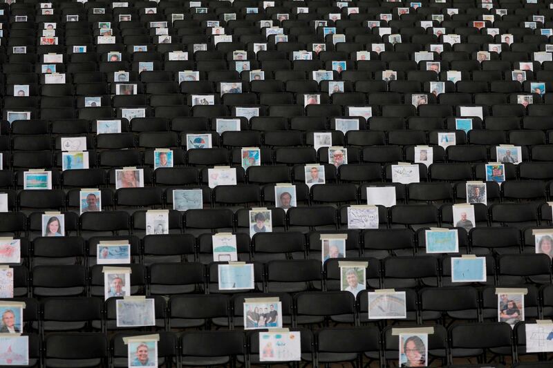 Portraits and drawings are displayed on chairs, amid the coronavirus pandemic, during a protest outside the Hamburg plant of European aircraft maker Airbus.  AFP