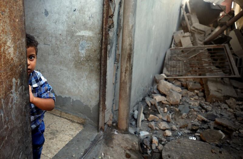 A boy looks out of his family's house in Al-Mughraqa, Gaza City. Reuters