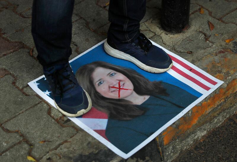 A protester stands on a portrait of the US Ambassador to Lebanon Dorothy Shea outside the Lebanese Foreign Ministry in Beirut. AP