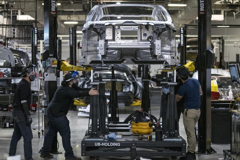 Workers assemble the Lucid Air prototype electric vehicle, manufactured by Lucid Motors Inc., at the company's headquarters in Newark, California, U.S., on Monday, Aug. 3, 2020. The final specs and design of the Lucid Air are due to be unveiled at an event in September and executives say customers can now expect delivery of the first batch of Airs in spring 2021. Photographer: David Paul Morris/Bloomberg