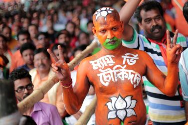 A Bharatiya Janata Party activist paints his body with party colors as supporters gather to hear a speech of Prime Minister Narendra Modi during a mass election campaign ahead of the 2019 general election. EPA