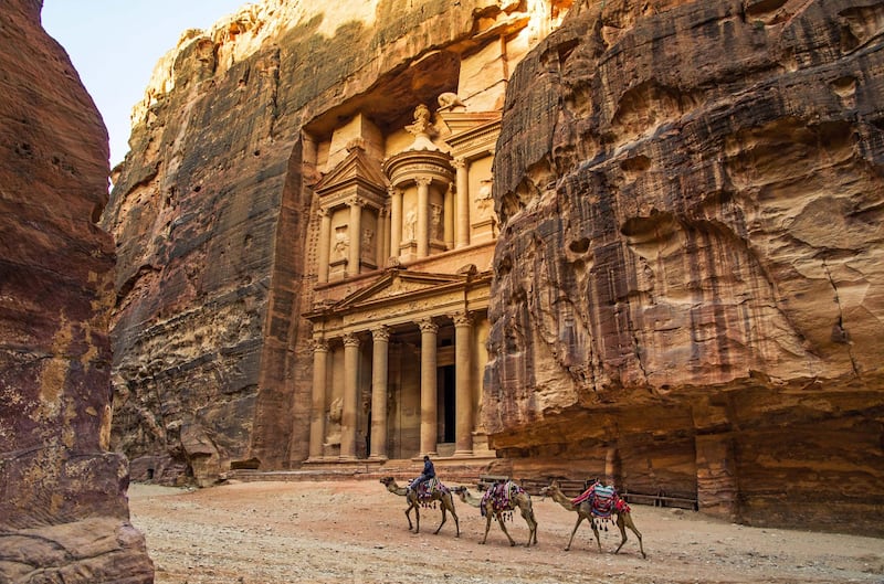 the Treasury at Petra in the morning. Camels passing by. Courtesy Four Seasons