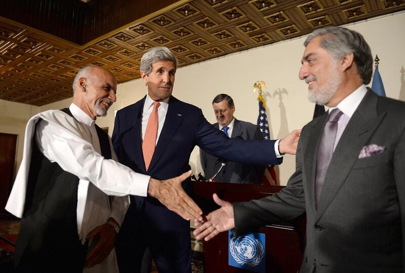 Afghan presidential candidate Ashraf Ghani, US Secretary of State John Kerry and Afghan presidential candidate Abdullah Abdullah shake hands during a joint press conference in Kabul on July 12. AFP Photo

