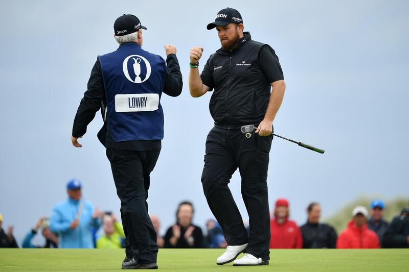 Lowry and his caddie Bo Martin react to his birdie on the 15th green. Getty Images