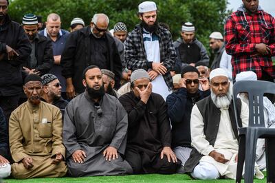 Mourners perform congregational prayers on the sidelines of the funeral of Haji Mohammed Daoud Nabi, 71, a victim of the Al Noor Mosque massacre in Christchurch on March 21, 2019.  New Zealand Prime Minister Jacinda Ardern on March 21 announced an immediate ban on the sale of assault rifles and semi-automatics in a muscular response to the Christchurch terror attack that killed 50 people. / AFP / Anthony WALLACE
