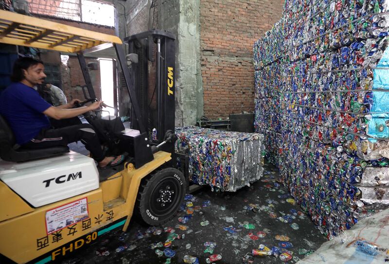 Crushed cans being stacked ready to recycle in Mokattem, Cairo.