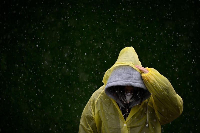 A woman wearing a face mask crosses a street in Beijing, China. AFP