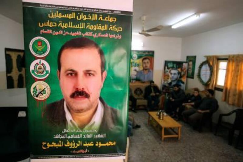 Men sit next to posters depicting senior Hamas military commander Mahmoud al-Mabhouh at his family house in the northern Gaza Strip January 29, 2010. Israel assassinated al-Mabhouh, who played a major role in a Palestinian uprising in the 1980s, in Dubai, an official in the Islamist group said on Friday. Israeli officials had no immediate comment. REUTERS/Mohammed Salem (GAZA - Tags: POLITICS CIVIL UNREST) *** Local Caption ***  SJS03_PALESTINIANS-_0129_11.JPG