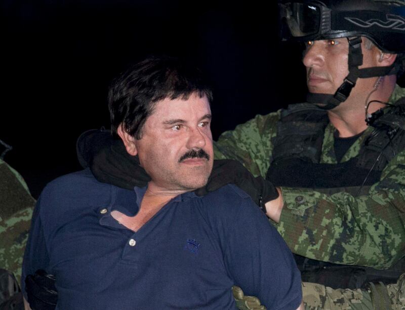 FILE - In this Jan. 8, 2016, file photo, Mexican drug lord Joaquin "El Chapo" Guzman is made to face the press as he is escorted to a helicopter in handcuffs by Mexican soldiers and marines at a federal hangar in Mexico City, Mexico. Notorious Mexican drug lord and escape artist Joaquin "El Chapo" Guzman is eager to go to trial, his lawyer said Thursday, Feb. 15, 2018 after a U.S. judge set Sept. 5 for jury selection in his drug-trafficking case. (AP Photo/Marco Ugarte, File)