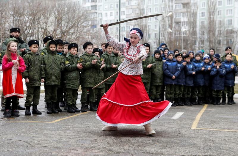 A student from the General Yermolov Cadet School performs with models of swords during celebrations of Maslenitsa, or Pancake Week, a pagan holiday marking the end of winter, in southern city of Stavropol, Russia. REUTERS