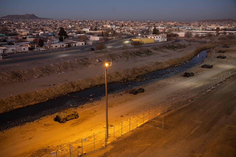 Texas National Guard soldiers line the Rio Grande at the US-Mexico in El Paso, Texas. Getty / AFP