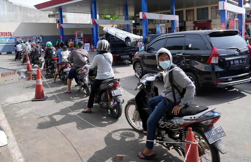Cars and motorcycles queue at a petrol station in Indonesia's capital Jakarta, as drivers try to beat the price increase. AP