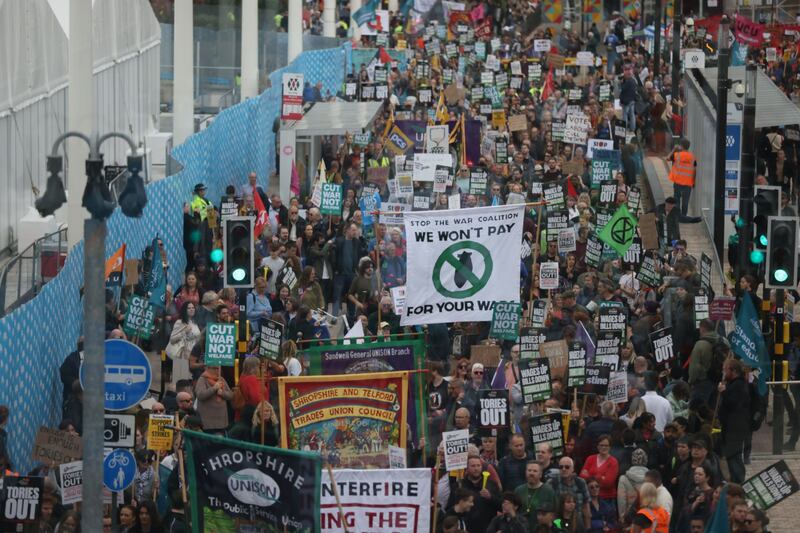 Protesters march with placards at a demonstration in Birmingham against the Conservative government as the party's conference started in the city. Bloomberg