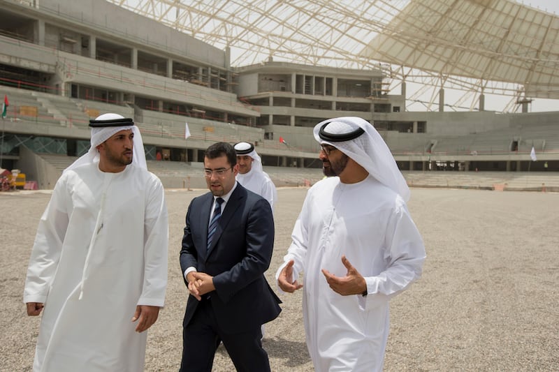 AL AIN, EASTERN REGION OF ABU DHABI, UNITED ARAB EMIRATES - May 08, 2013: HH General Sheikh Mohamed bin Zayed Al Nahyan Crown Prince of Abu Dhabi Deputy Supreme Commander of the UAE Armed Forces (R), inspects the construction of the Hazza Bin Zayed Stadium, which will serve as the new home ground of Al Ain Football Club. Seen with HE Mohamed Mubarak Al Mazrouei Under-Secretary of the Crown Prince Court of Abu Dhabi (L), and Kareem Nagy Hassan CEO of Al Qattara Investments (2nd L). .( Ryan Carter / Crown Prince Court - Abu Dhabi ).---