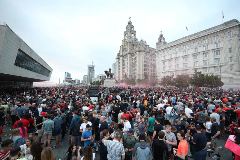 Liverpool fans let off flares outside the Liver Building in Liverpool. AP