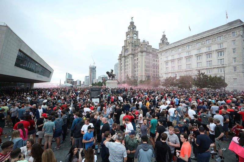 Liverpool fans let off flares outside the Liver Building in Liverpool. AP