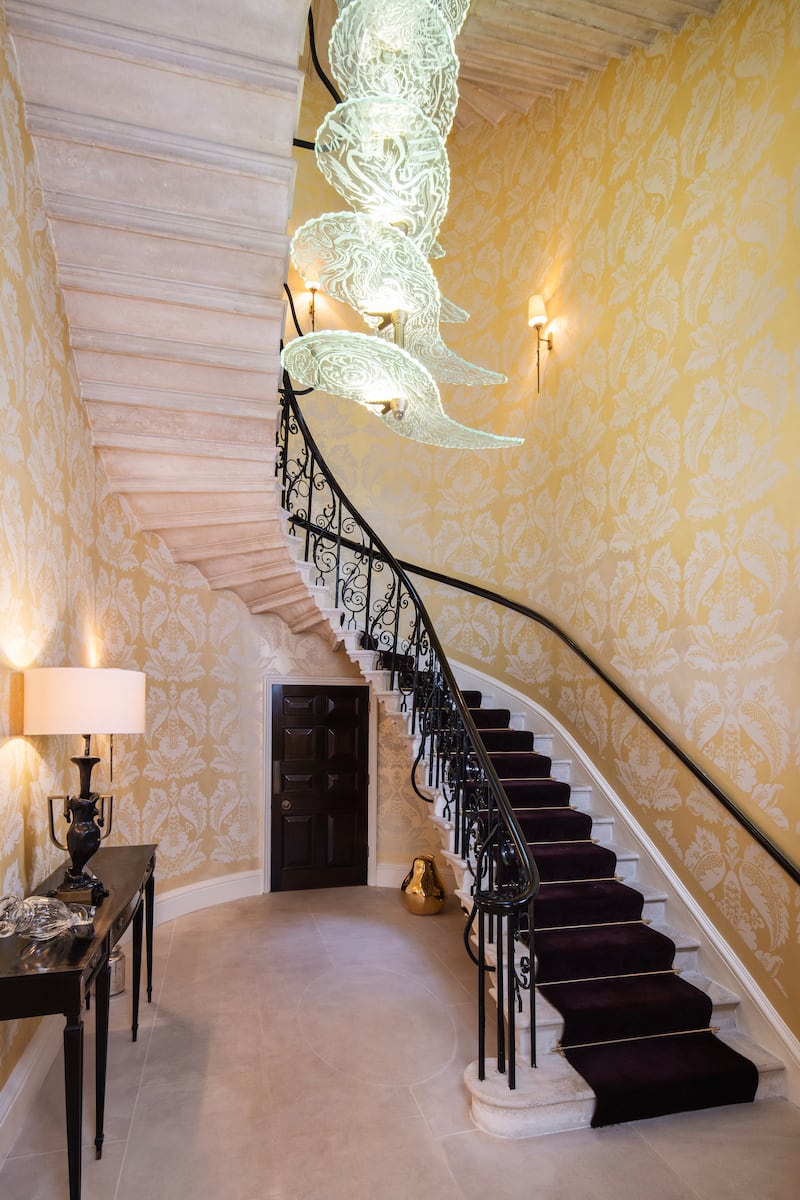 A sweeping staircase connects the levels. 