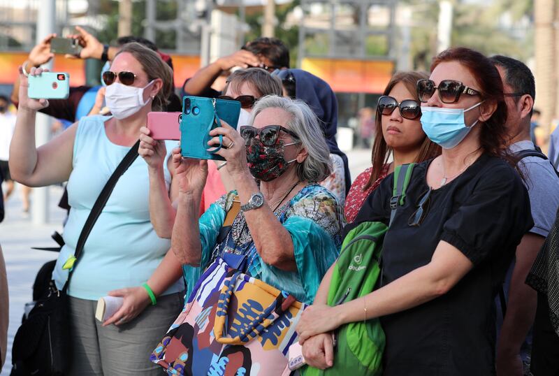 Visitors record footage of Expo attractions as souvenirs of the event.