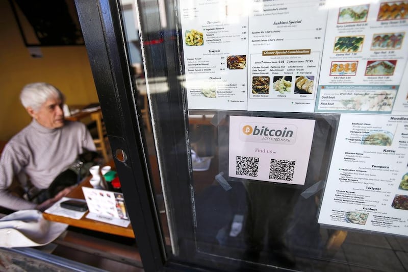 A Bitcoin logo is seen at the window of Nara Sushi, a San Francisco restaurant that accepts Bitcoin as payment. Stephen Lam  / Reuters