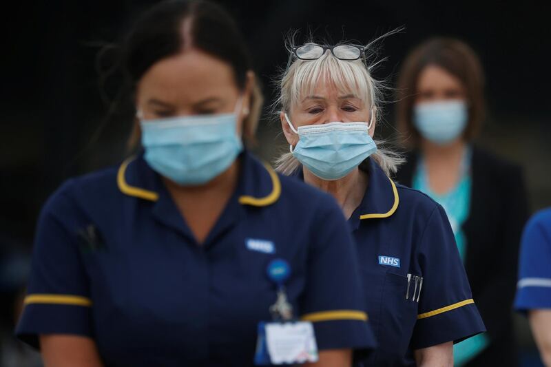 Hospital staff observe a minute's silence outside the Aintree University Hospital in Liverpool. Reuters