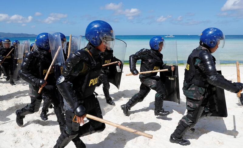 Anti-riot police take part in a drill simulating a protest in preparation for the temporary closure of the holiday island Boracay in the Philippines. Erik De Castro / Reuters