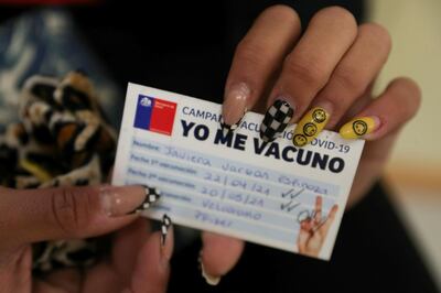 Olympics - Chilean athletes and staff travelling to Tokyo for the Olympics receive COVID-19 vaccine - Santiago, Chile - May 20, 2021 Chilean athlete Javiera Vargas shows a vaccination record card reading 'I get vaccinated' after receiving the Pfizer-BioNTech vaccine against the coronavirus disease (COVID-19). REUTERS/Ivan Alvarado
