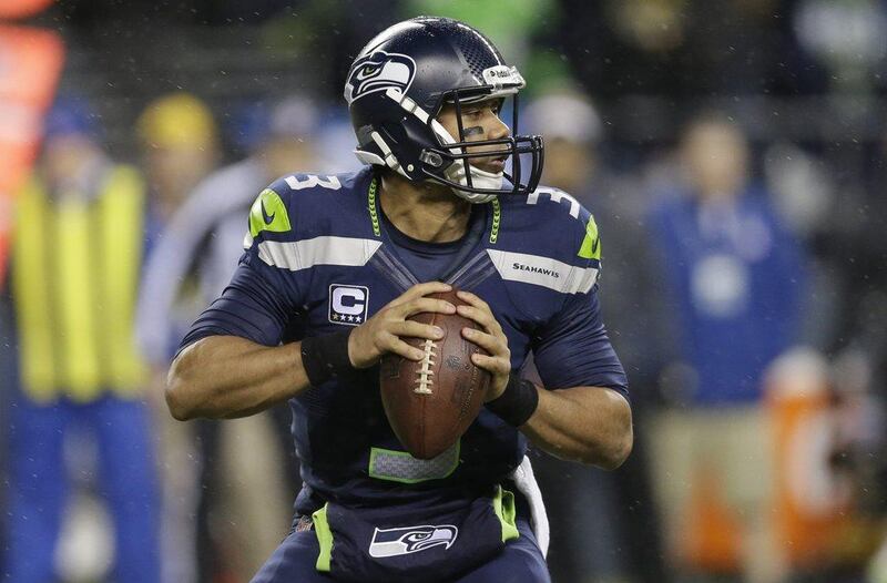 Russell Wilson threw for 310 yards and three touchdowns on Monday night. Elaine Thompson / AP