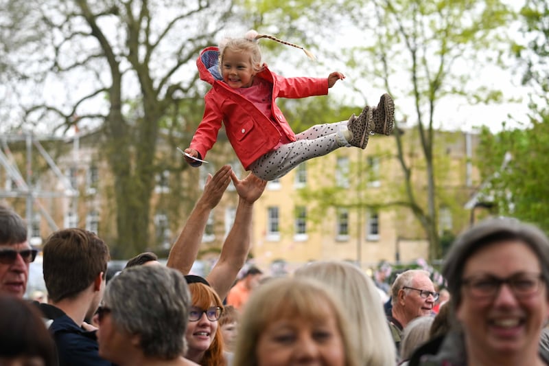 Sophia, three, laughs as she is thrown up in the air during The Big Lunch at The Long Walk in Windsor. Getty Images