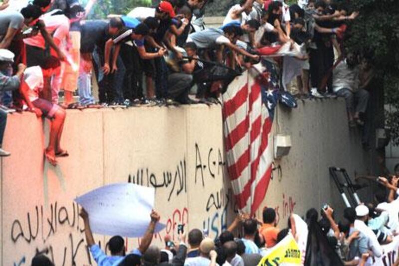 Egyptian protesters tear down the US flag at the US embassy in Cairo on September 11.