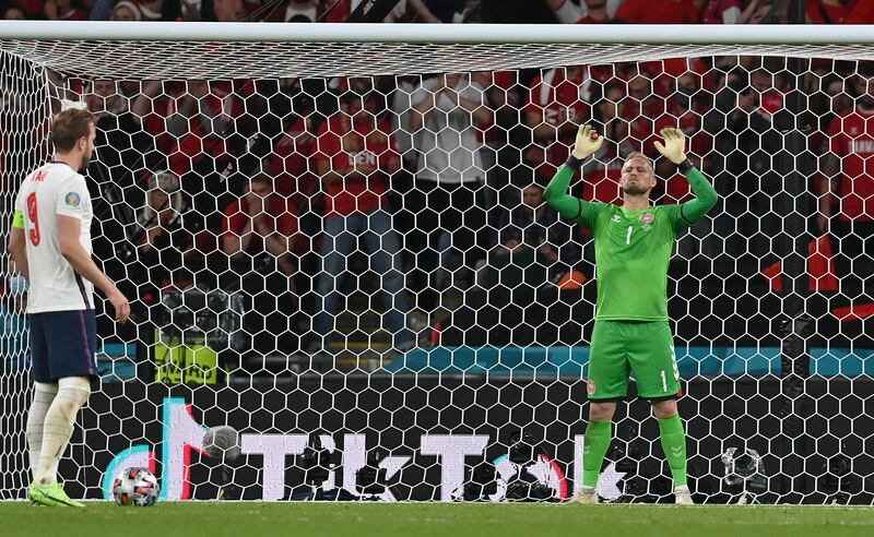 Denmark goalkeeper Kasper Schmeichel prepares for England's Harry Kane, left, to take a penalty during the Euro 2020 semi-final. AP