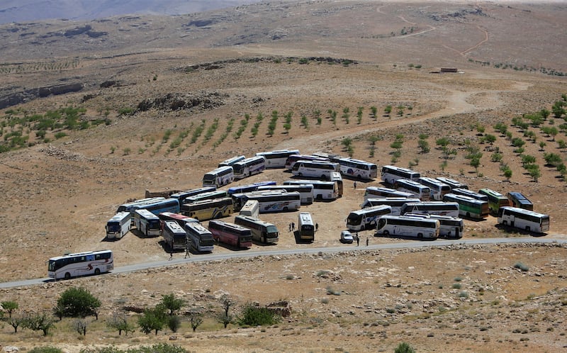Buses that will transfer Nusra Front militants are seen parked in Jroud Arsal, Syria-Lebanon border, July 31, 2017. REUTERS/Ali Hashisho